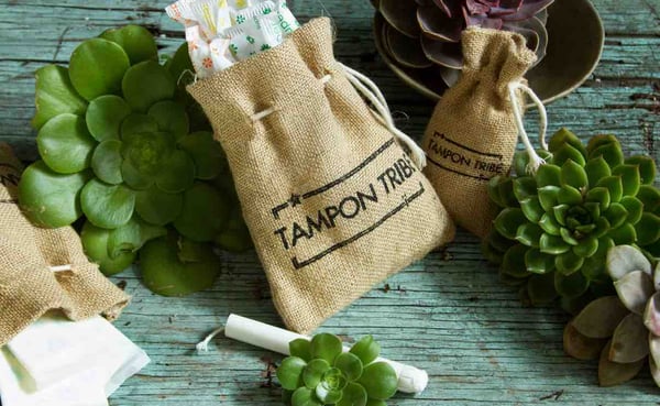 Image of hessian bag filled with organic cotton tampons and with Tampon Tribe logo