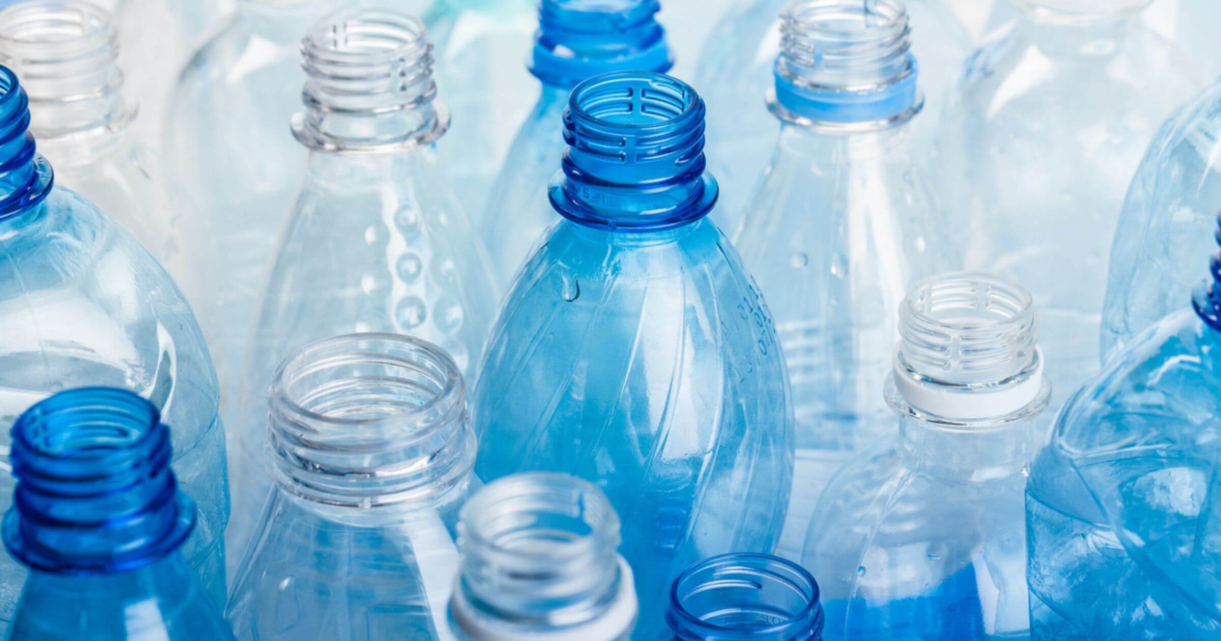 Rows of transparent and blue plastic bottles