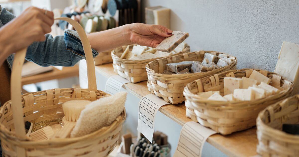 Someone holding a backset picking up and looking at plastic-free sop bars