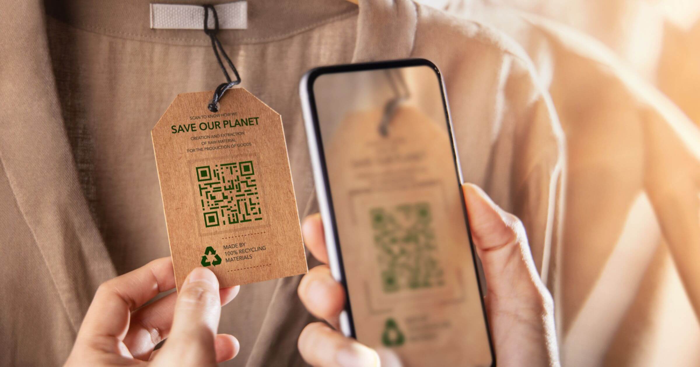 Someone looking at a label on a piece of clothing with a QR code on it for sustainability information